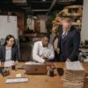 A multicultural team working together in a modern office setting, focusing on documents.